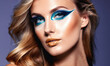 © Miklos - A woman with long blonde hair looks at the camera with dramatic blue eyeshadow
