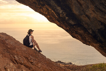 Hiker sitting enjoying the sunrise view 