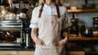© Taras - Woman in empty apron. Copy space in white uniform. Waiter wearing black mockup wear for brand or label. Kitchen or restaurant worker with copyspace apron