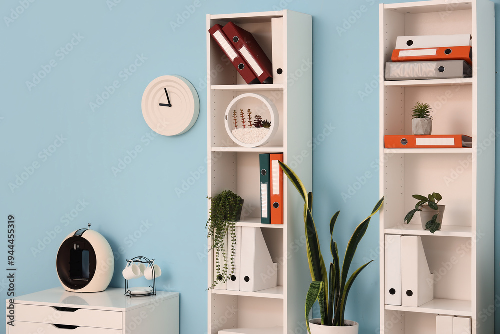 Shelf units with document folders and plants in office