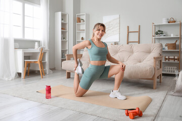 Sticker - Young female fitness trainer exercising on yoga mat at home