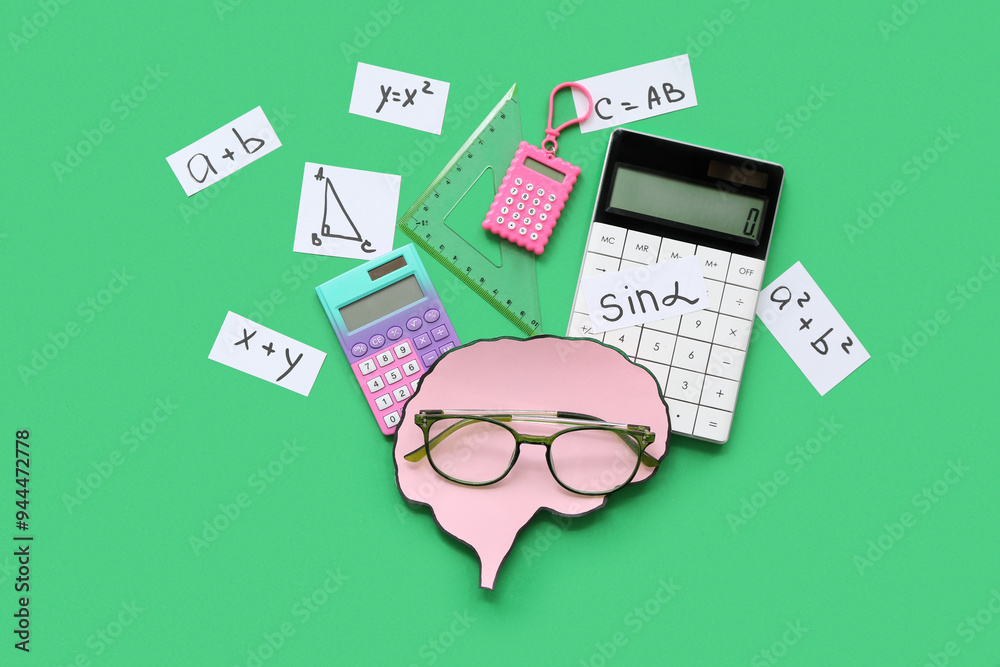 Paper brains with eyeglasses, math formulas and equations, calculators and triangle ruler on green background