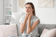 © Pixel-Shot - Young woman suffering from tooth ache at home
