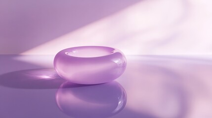 Wall Mural - A purple glass bowl sits on a table, reflecting the light from a window