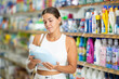 © JackF - Young woman shopper choosing laundry gel in store