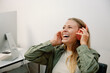 © Franci Leoncio - cheerful young business woman with headphones in office