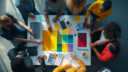 Poster - Collaborative team brainstorming at a modern workspace with colorful designs and materials gathered on the table