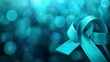 © Helois - Teal awareness ribbon on a blue bokeh background.