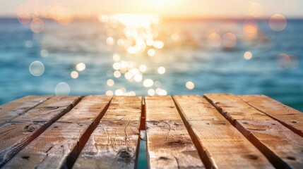 A rustic wooden dock facing the ocean, illuminated by the golden glow of a sunset with bokeh light reflections on the water.