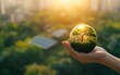 © AhmadTriwahyuutomo - Hand Holding Globe with Renewable Energy Icons Symbolizing Personal Responsibility for Carbon Neutrality