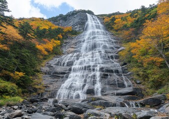 Wall Mural - Majestic Waterfall With Fall Foliage: A Stunning Vertical Cascade Through Autumn-Colored Forest, Offering a Breathtaking Nature Experience