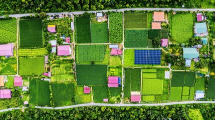 Aerial View of Green Farmland with Solar Panels and Houses