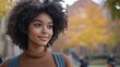 © BOJOShop - Happy African American Female Student with Backpack in Autumn