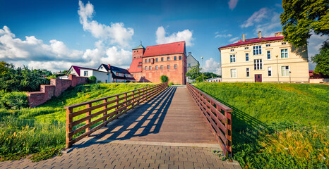 Poster - Panoramic summer view of Castle of the Dukes of Pomerania. Colorful morning cityscape of Darlowo town with wooden pedestrian bridge over the defensive ditch, Poland, Europe. Travel the world..