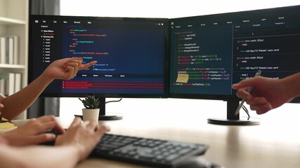 Slow motion back end software developer engineer for computer programming working together on debugging writing computing code, solving complex algorithms display on monitor in office. Burgeoning