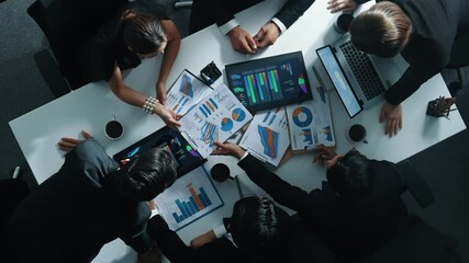 Wall Mural - Top down aerial view of professional businessman handed out financial statistic to analyst data investment graph. Group of diverse investors brainstorming and planning marketing strategy. Directorate.