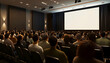 © Swaha - Audience in a conference room looking at a blank screen.