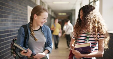 Wall Mural - Education, books and girl students walking in a hallway at school, talking or laughing at a joke together. Kids, funny and a young friends in a corridor for scholarship, learning or child development