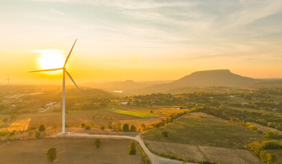 Wind farm field and sunset sky. Wind power. Sustainable, renewable energy. Wind turbines generate electricity. Sustainable development. Green technology for energy sustainability. Eco-friendly energy.