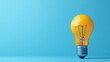 © khonkangrua - Single yellow lightbulb standing out against a bright blue background, symbolizing creativity, innovation, and bright ideas.