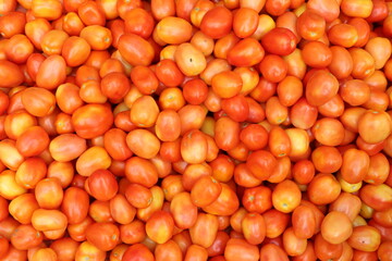 Heap of red ripe tomatoes in a vegetable whole sale market in India