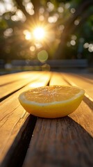 Wall Mural - A lemon half on a wooden surface with the sun shining in the background. AI.