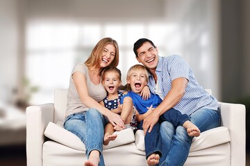 Canvas Print - Happy young family relaxing at home