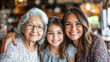 © ЮРИЙ ПОЗДНИКОВ - Three generations of women smiling together in restaurant