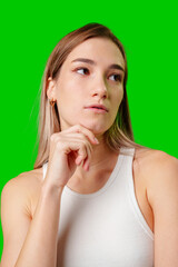 Wall Mural - Thoughtful Woman Wearing White Tank Top Against Green Screen Background