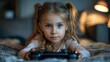 © Sandu - Young Girl Playing Video Games on Bed