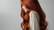 © Tetiana - A woman showcases her vibrant red hair styled in gentle waves against a simple backdrop