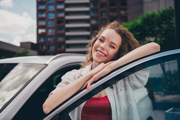 Poster - Photo of dreamy pretty lady dressed white shirt smiling driving automobile enjoy traffic outdoors urban city street