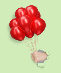 Aufkleber - Childrens hand holding red shiny balloons through the hole in mint paper