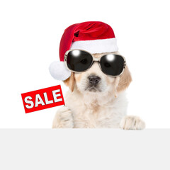 Aufkleber - Funny Golden retriever puppy wearing sunglasses and santa hat shows signboard with labeled 
