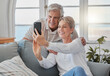 © DavisShared/peopleimages.com - Selfie, relax and senior couple on sofa for social media post, memory and profile picture. Retirement, marriage and mature man and woman on video call for bonding, love and online in living room