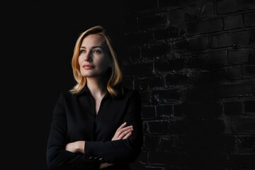 Canvas Print - Handsome business woman isolated on black with arms crossed Handsome business woman isolated on black with arms crossed. black background