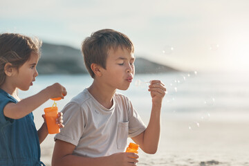 Canvas Print - Vacation, boy and girl with bubbles on beach for playing, summer fun and seaside game on holiday with fun. Children, siblings and together for travel adventure, childhood memories and bonding.