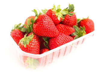 Wall Mural - Fresh appetizing strawberries in a plastic tray onwhite background