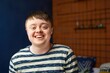 © alisaaa - Smiling From Ear to Ear A teenage Down syndrome boy looking at the camera, smiling and looking happy.