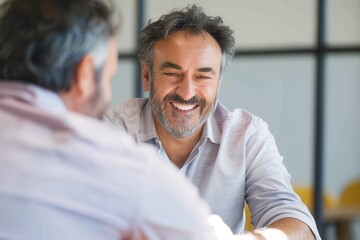 Poster - Cheerful mature businessman smiling in meeting Candid portrait of confident man in his 40s at conference table, business meeting, professional occupation, relaxation, enjoyment