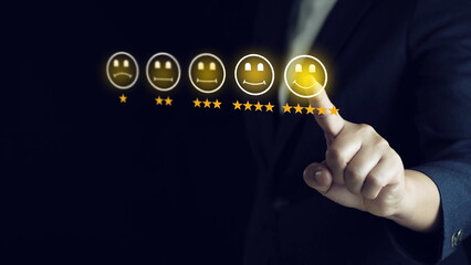 Wall Mural - Customer service evaluation concept.Businessman pressing smiley face emoticon on virtual touch screen.
