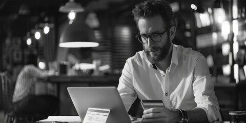 Aufkleber - A person working on a laptop with a credit card nearby, possibly for online shopping or banking