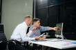 © laddawan - Two business workers talking on the smartphone and using laptop