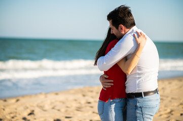 Romantic couple hugging on the beach