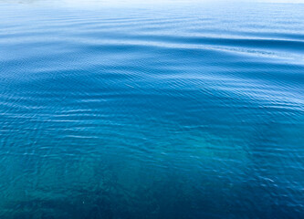 Ocean sea water surface calm with ripple, shades of blue background,