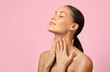 © Home-stock - Attractive adorable serene young woman touching pure neck skin isolated over pink background, free space