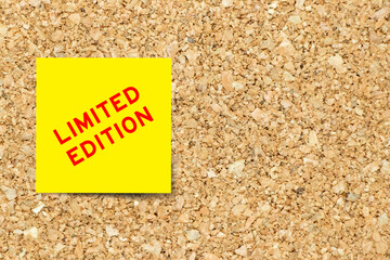 Sticker - Yellow note paper with word limited edition on cork board background with copy space