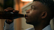 © Yuliia - Addicted upset drunk African American depressed stress man drinking alcohol sad suffer problem drink beer with bottle ethnic guy biracial male addiction stressed mental worry bad habit home kitchen