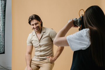 Handsome model posing for professional photographer in studio.