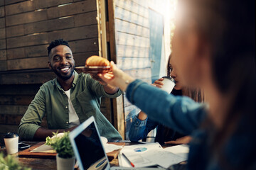 Wall Mural - Group of business people, table and food at meeting, team building and together for gathering at cafe. Colleagues, celebration and party for break as staff, worker or employee at event in restaurant